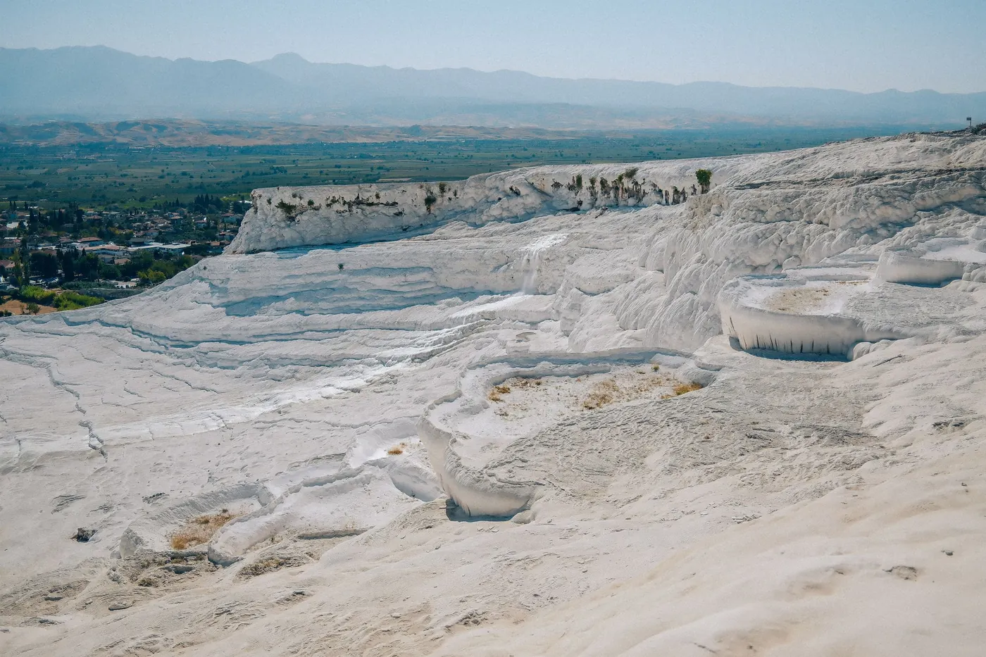 Wide view over the travertine slopes of Pamukkale towards the plain of Denizli